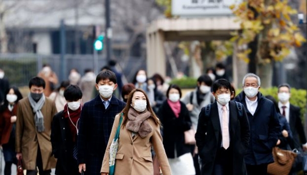 28일 일본 도쿄에서 마스크를 쓴 시민들이 한 역에서 걸어 나오고 있다. 스가 히데요시 일본 총리는 코로나19와 관련해 기업에 법적 구속력을 부여하고 위반자를 처벌하며 경제적 보상을 포함하는 내용을 포함한 법안을 제출할 것이라고 밝혔다. 2020.12.28. [뉴시스]